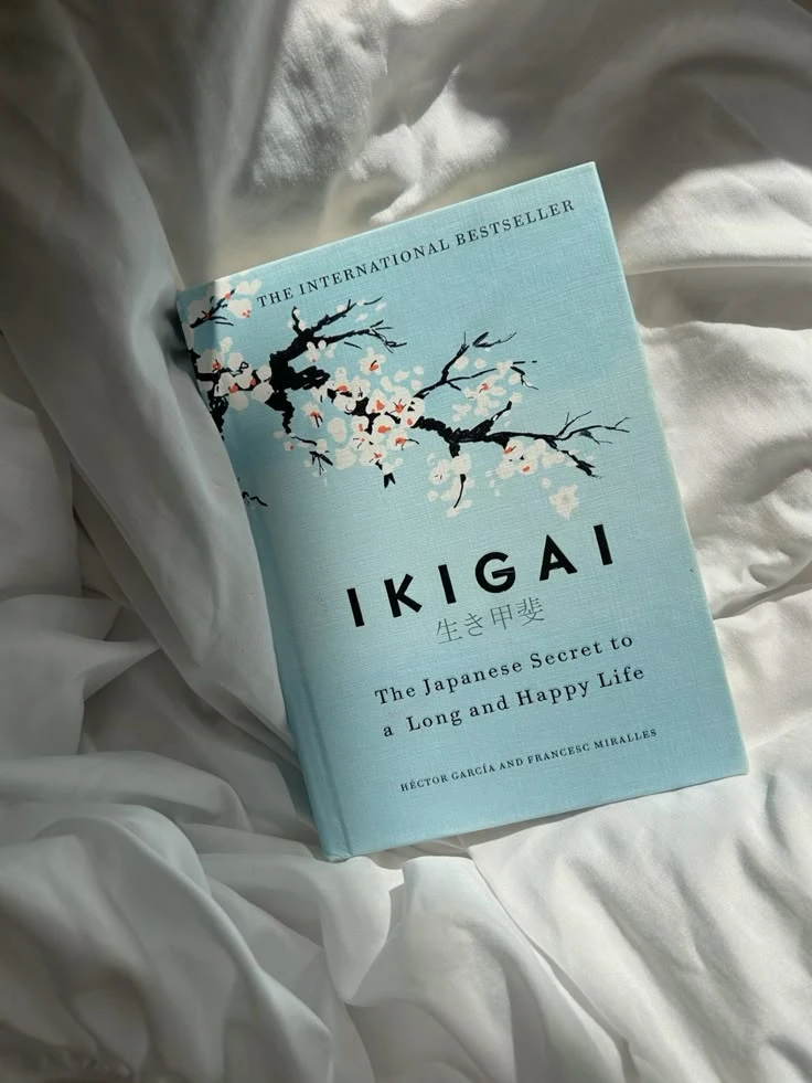 A hardback book lying on white linen in morning light